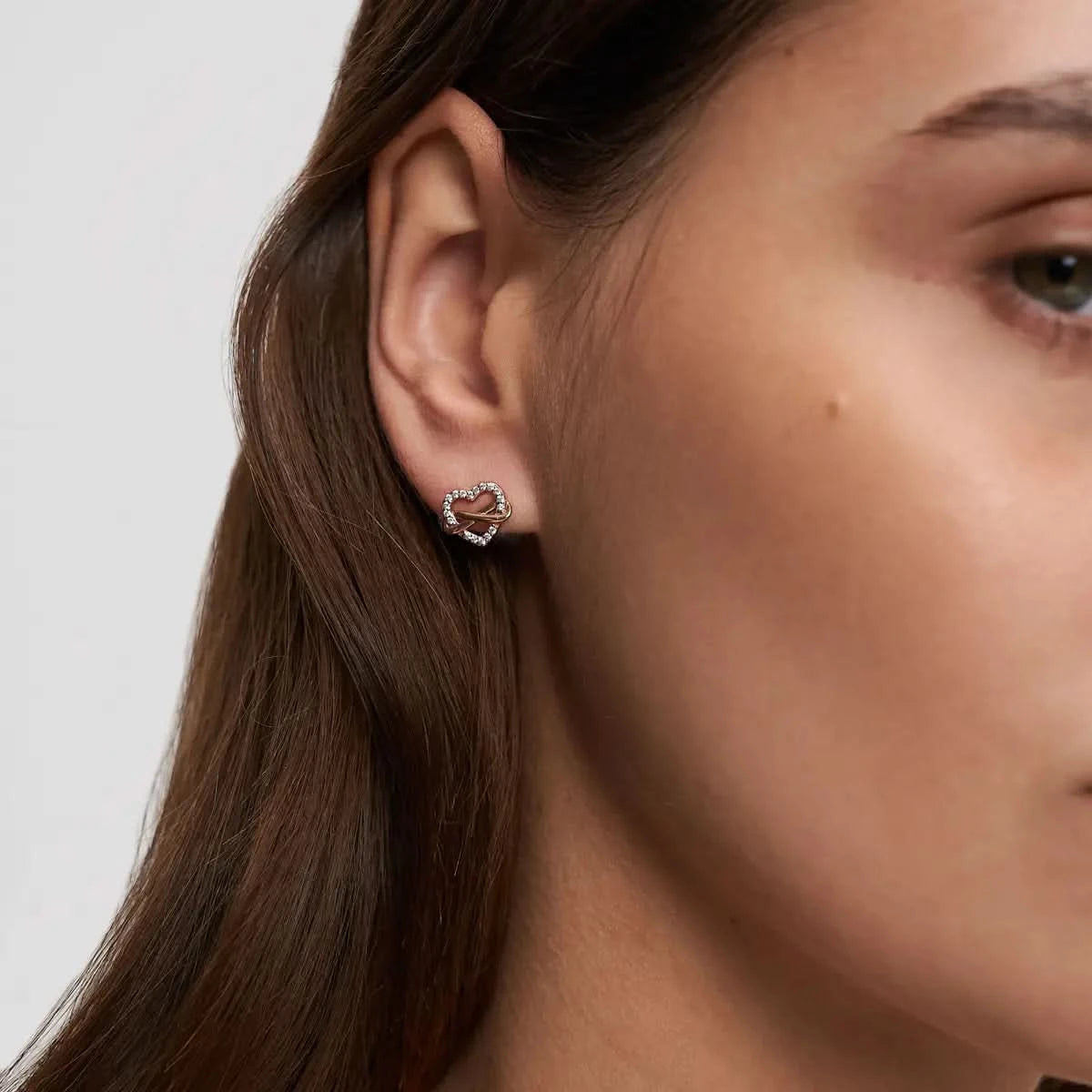 alt
Silver colored hoop earring with a small, dangling, silver colored charm.