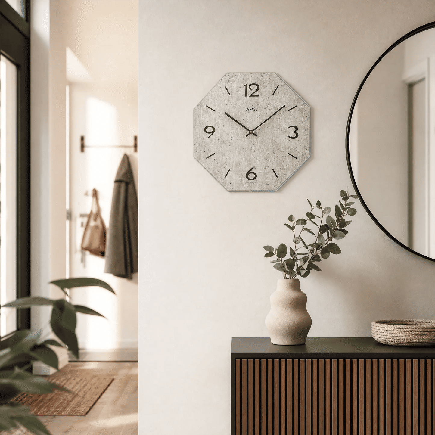 Wall clock on the wall with a gray dial, numbers 3, 6, 9, 12, and hands