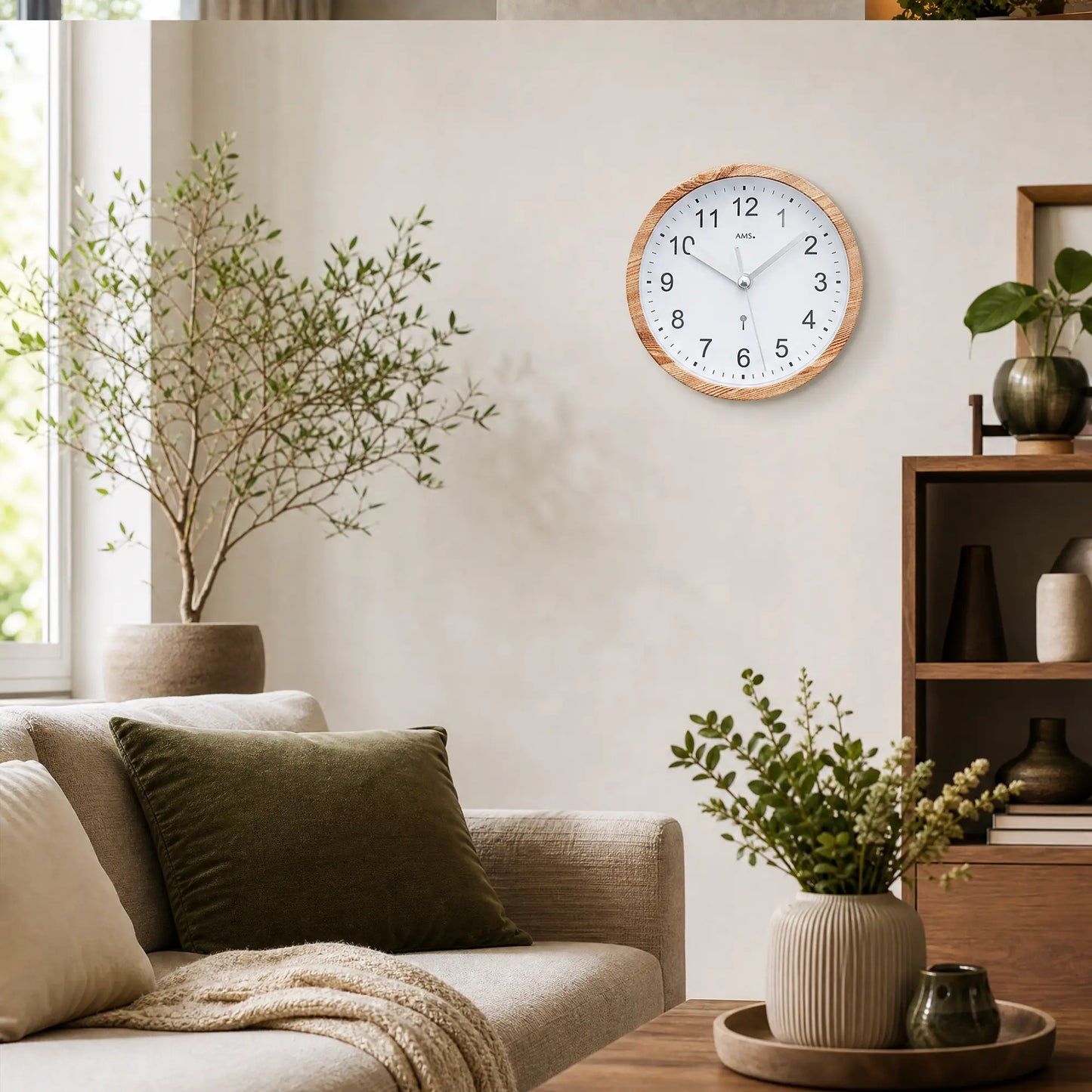Wall clock with wood-look frame and white dial on the wall