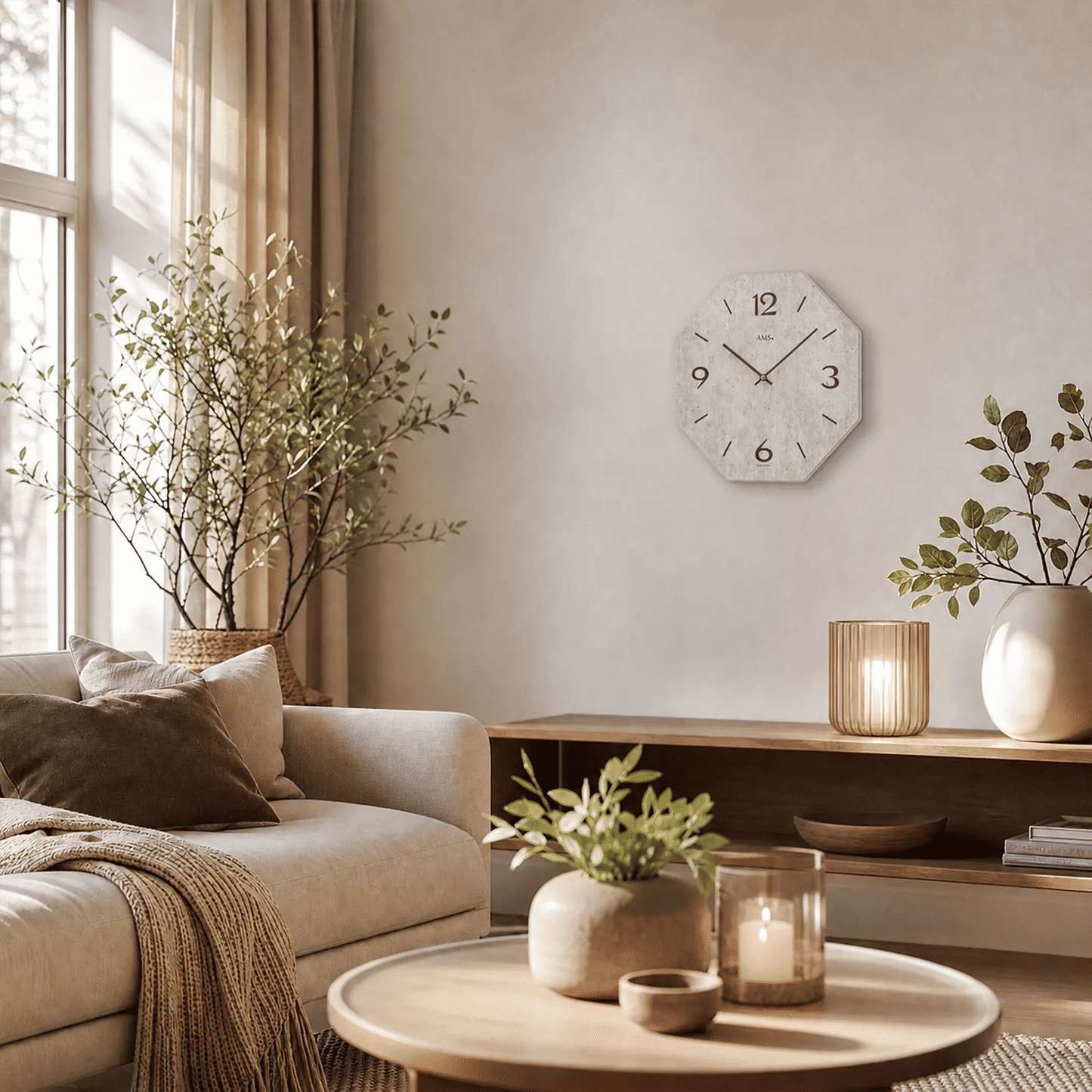 Wall clock on the wall with a gray dial, numbers 1–12, and black hands