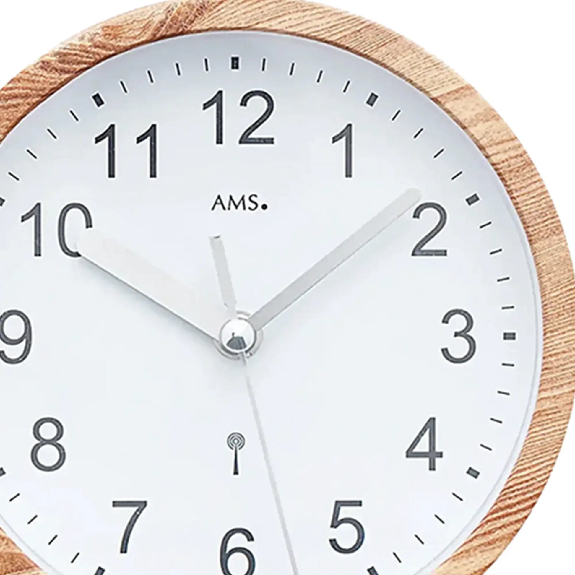 Nahaufnahme: Wanduhr mit Holzoptik-Rand, weißem Zifferblatt, AMS-Logo und Zeigern