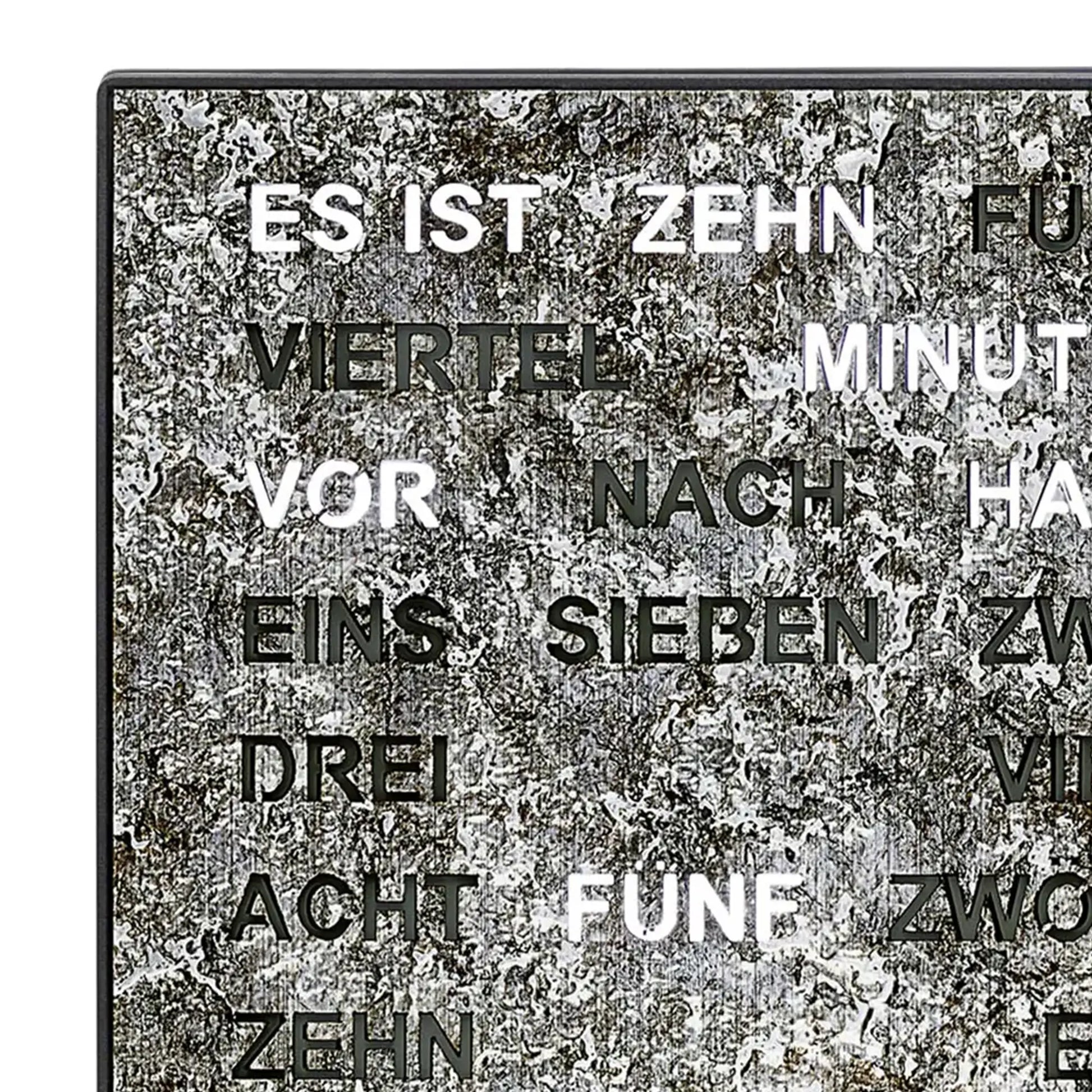 Nahaufnahme Wortuhr LED: silbern gesprenkelte Metallfläche mit teilweise sichtbaren beleuchteten Worten