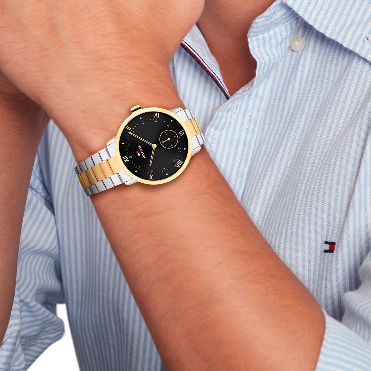 Tommy Hilfiger Herrenuhr mit schwarzem Zifferblatt und zweifarbigem Armband am Handgelenk