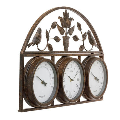 Wanduhr mit drei runden Zifferblättern, antik wirkendem Metallrahmen und Vogelmotiv oben